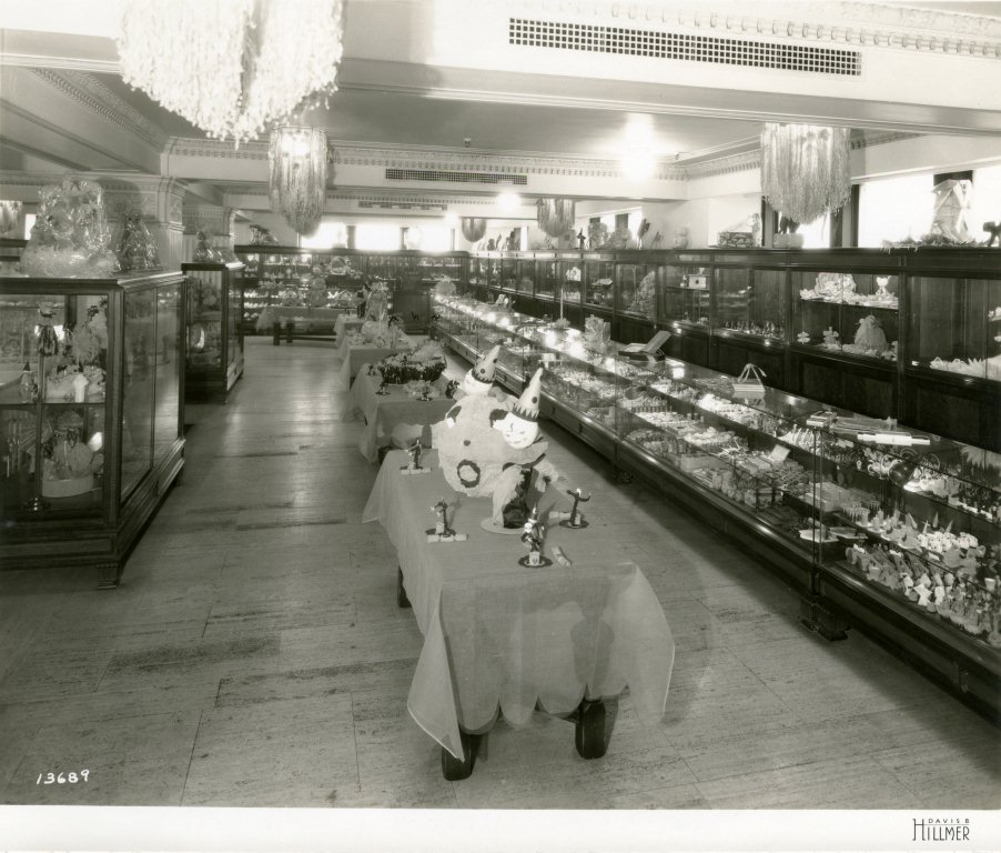 Also from the 1920s, this photo from the Davis Hillmer Collection shows retail displays dressed with clown papier-mâché centerpieces and skeleton place holders, and stocked with edible and ornamental treats.