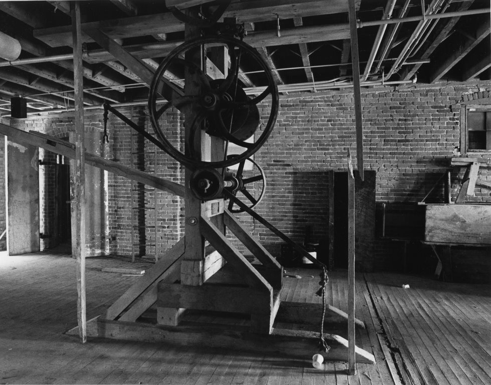 Tannery equipment remained in place until redevelopment began, like this hoist on the 4th floor (Carmen Truice, 1982).