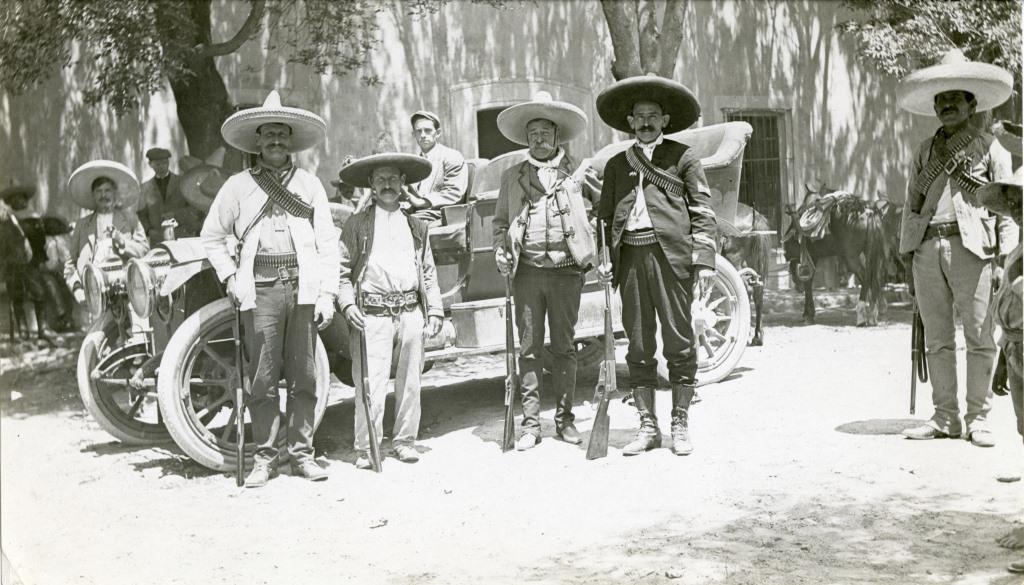 Mexican revolutionaries standing next to a Packard, c. 1915.