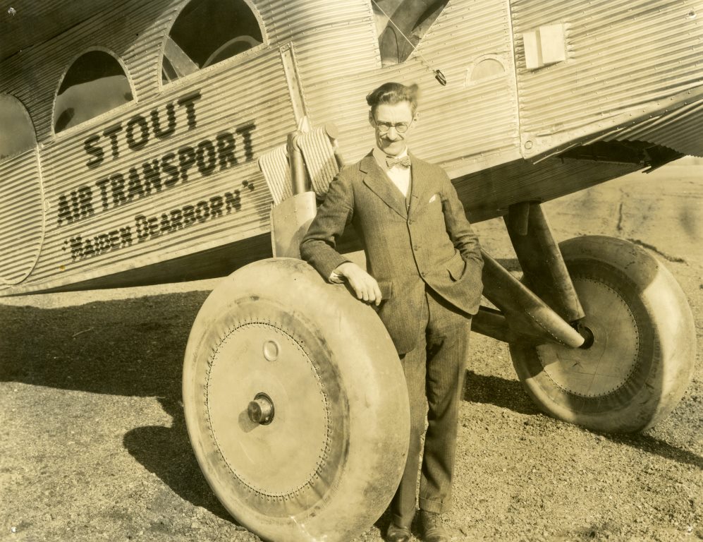 Stout standing underneath a Stout 2-AT Pullman, “Maiden Dearborn”, 1925.