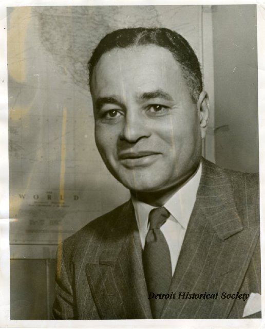 Dr. Ralph J. Bunche poses in front of a world map in this c. 1950 portrait.