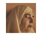 Close up of a woman with her eyes closed, she is wearing a hijab.