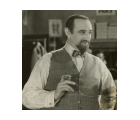 Still from the 1932 film Uncle Moses, showing a man with a beard wearing a vest and bow tie, holding a cigar.